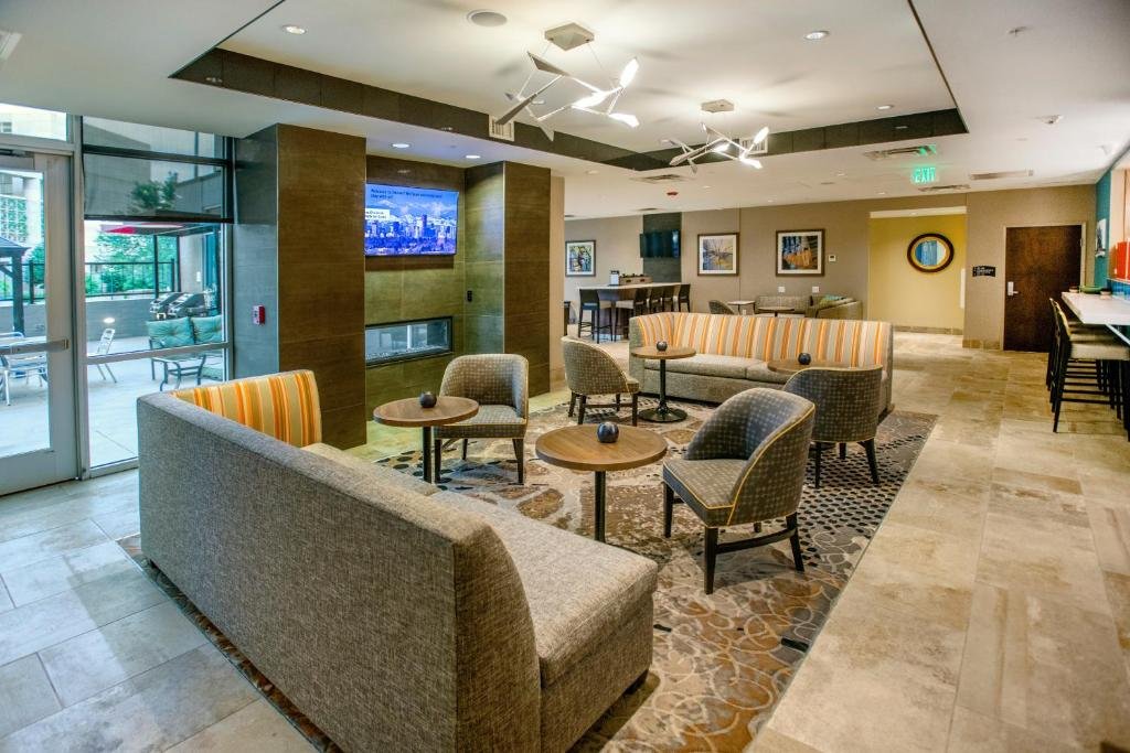 Staybridge Suites Denver Downtown by IHG hall with gray furniture