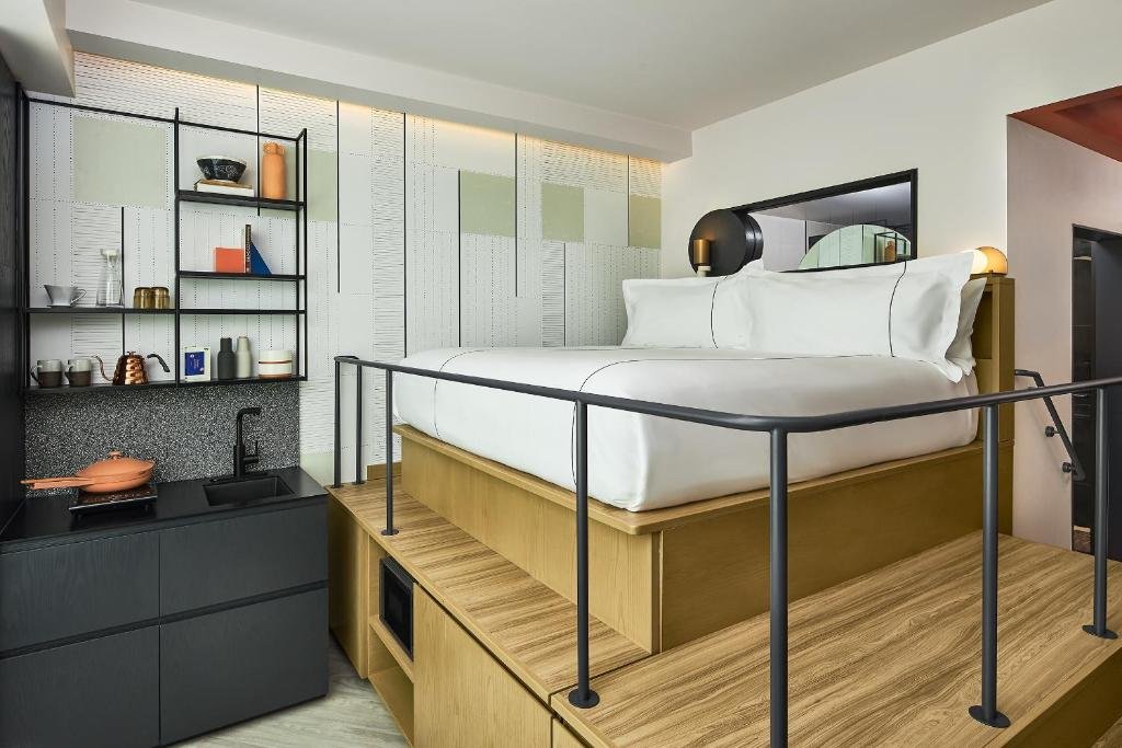 Catbird Hotel bed on the podium with kitchen