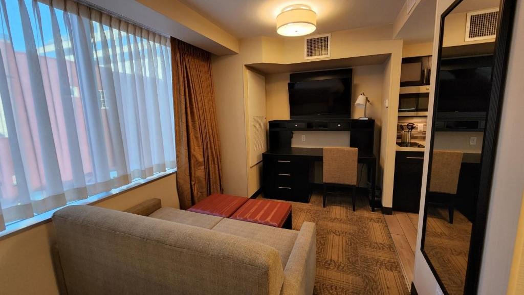 Staybridge Suites Denver Downtown by IHG room with sofa and TV