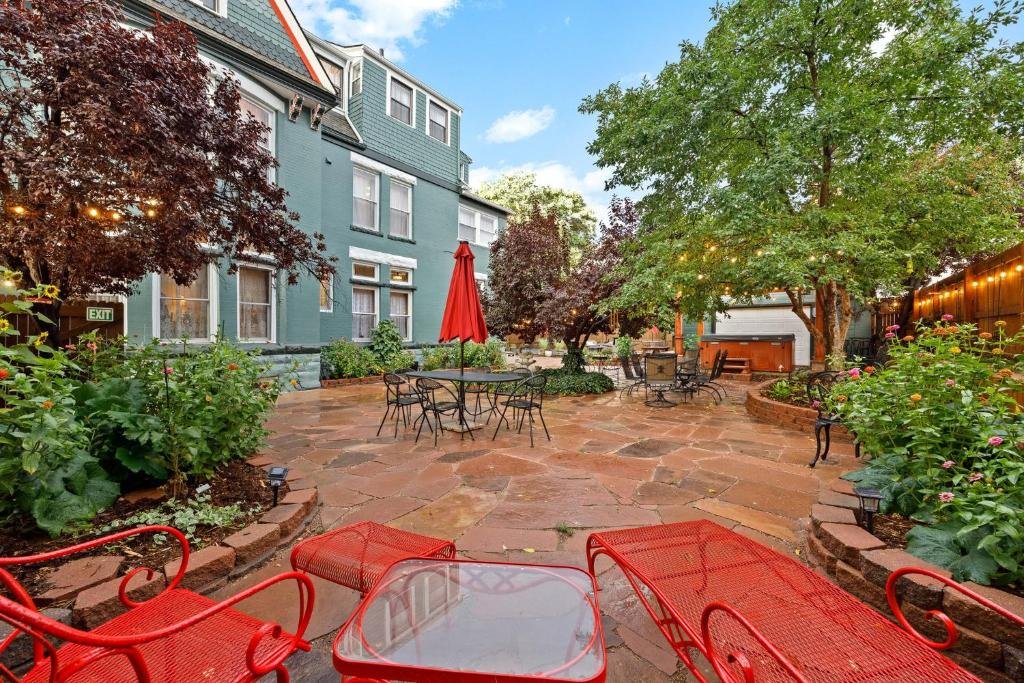 Flora House Denver Cozy courtyard with red tables