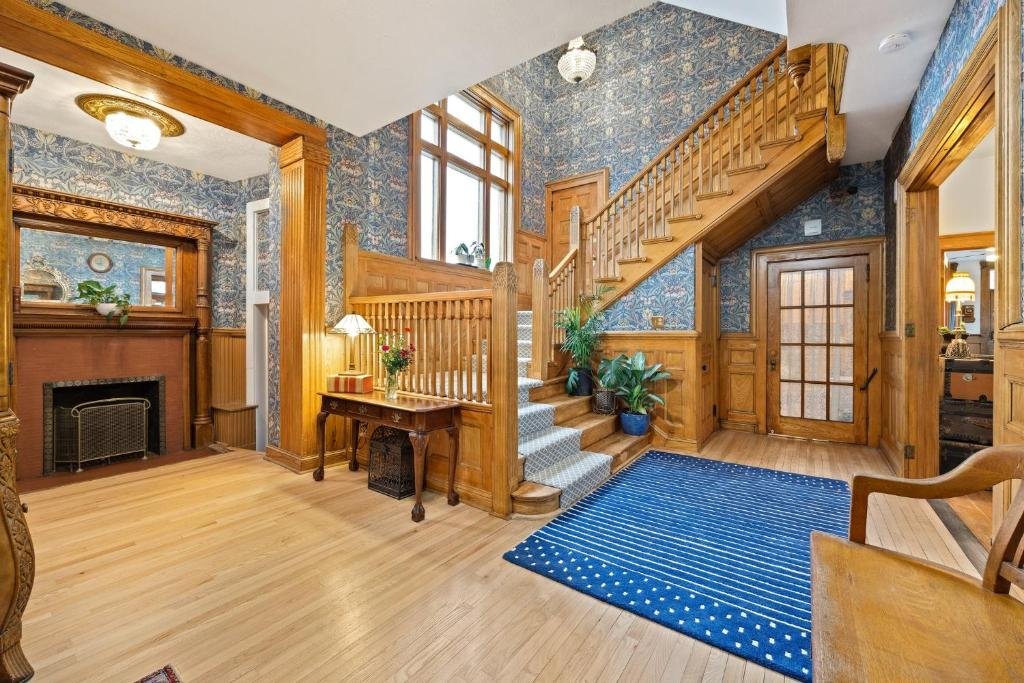 Flora House Denver A bedroom with wooden stairs and a carpet