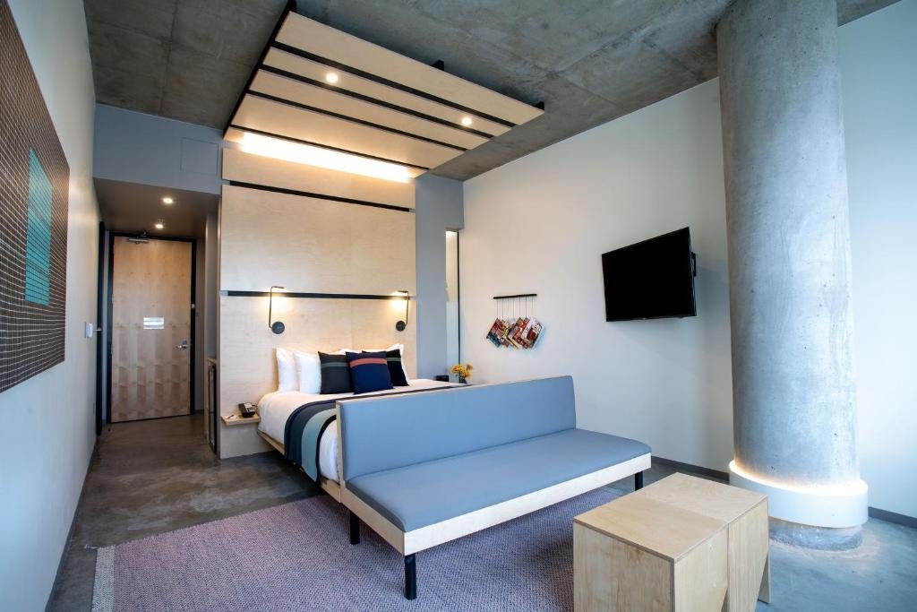 The Source Hotel Bed with gray bench